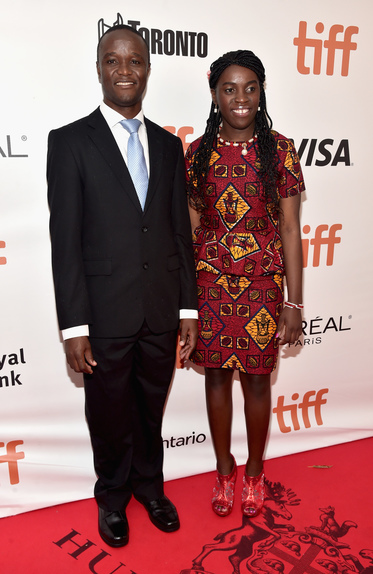 Chess Coach and Director of Sports Outreach in Uganda, Robert Katende (L) and Ugandan national chess champion Phiona Mutesi arrive at the world premiere of Disney’s “Queen of Katwe” at Roy Thompson Hall 